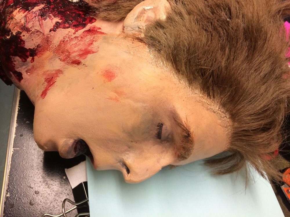 After being painted and having a wig glued on, it was super realistic and gory!