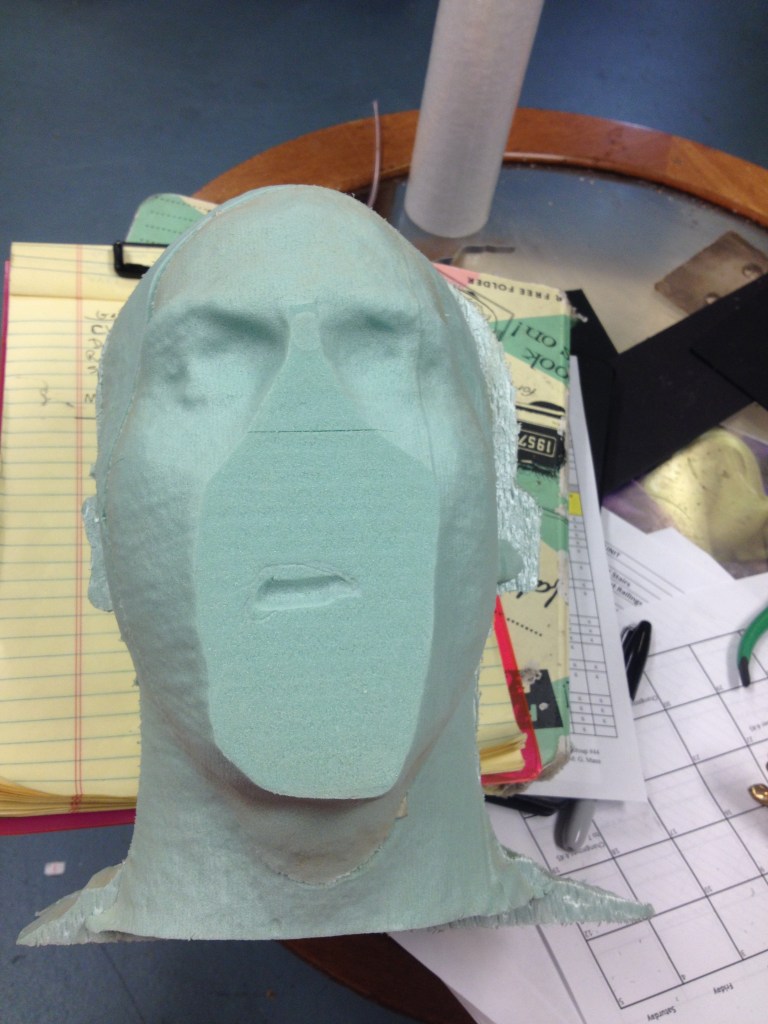 At the Prop shop, Kate CNC milled sheets of foam and built the head. They put a brick in the center to give it the correct weight. 