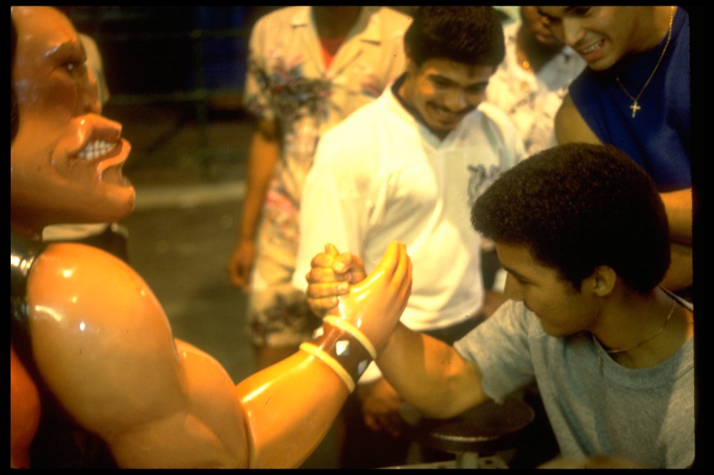Man against the arm wrestling machine